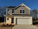Two-story house with neutral siding, white garage door, and landscaping at 174 Salem Springs Ln, Statesville, NC 28625