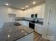 Modern kitchen with white cabinets and granite countertops at 174 Salem Springs Ln, Statesville, NC 28625