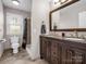 Bathroom featuring double vanity, granite counters, and a shower with tile surround at 204 Jonas Dr, Lincolnton, NC 28092