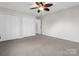 A neutral bedroom with a ceiling fan, large closets, and soft carpeting at 204 Jonas Dr, Lincolnton, NC 28092