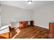 Spacious bonus room with hardwood floors and custom-built desk and cabinets, perfect for office space at 204 Jonas Dr, Lincolnton, NC 28092