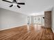Open-concept living room with hardwood floors, fireplace, and ceiling fan at 204 Jonas Dr, Lincolnton, NC 28092