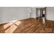 Bright and open living room with hardwood floors and French doors to other parts of the house at 204 Jonas Dr, Lincolnton, NC 28092