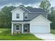Charming two-story home with a gray and white exterior, showcasing a welcoming front entrance and an attached garage at 282 New Salem Rd, Statesville, NC 28625