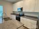 Modern kitchen featuring granite countertops, stainless steel appliances, and sleek white cabinets with ample storage at 282 New Salem Rd, Statesville, NC 28625