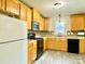 Galley kitchen with wood cabinets and modern appliances at 606 Carver St, Kannapolis, NC 28083