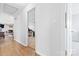Hallway with wood floors offering a view into a room with shelving at 2351 Hudspeth Rd, Catawba, NC 28609