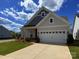 Beautifully maintained single-Gathering home features neutral siding, a lush green lawn, and a two-car garage at 405 Northgate Blvd, Indian Trail, NC 28079