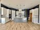 Spacious kitchen features white cabinets, stainless steel appliances, granite countertops, and stylish lighting at 405 Northgate Blvd, Indian Trail, NC 28079