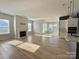 Bright and airy living room featuring hardwood floors, a fireplace, lots of natural light, connected to kitchen at 405 Northgate Blvd, Indian Trail, NC 28079