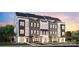 Modern townhome featuring a painted brick facade, black trimmed windows and professionally landscaped entrance at 6025 Countess Dr # 54, Charlotte, NC 28217