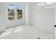 Bright, spacious bedroom with neutral walls, large windows, and a modern aesthetic at 6025 Countess Dr # 54, Charlotte, NC 28217