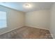 Cozy bedroom features neutral carpet, a window for natural light, and ample space at 7108 Kinley Commons Ln, Charlotte, NC 28278
