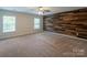 Spacious carpeted bedroom with natural light and an accent wooden plank wall at 7108 Kinley Commons Ln, Charlotte, NC 28278