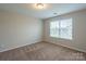 Bright bedroom with neutral walls and carpet features a sun-filled window at 7108 Kinley Commons Ln, Charlotte, NC 28278