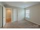 Bedroom showcasing neutral walls, carpet, and natural light filtering through a window at 7108 Kinley Commons Ln, Charlotte, NC 28278