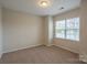 Neutral bedroom with carpeted floors and a bright window offering natural light at 7108 Kinley Commons Ln, Charlotte, NC 28278