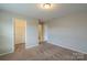 The bedroom features neutral walls and carpet, and access to the ensuite bathroom and closet at 7108 Kinley Commons Ln, Charlotte, NC 28278
