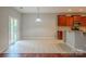 Bright dining area featuring sliding door access to the backyard and kitchen with granite countertops at 7108 Kinley Commons Ln, Charlotte, NC 28278