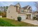 Side view of a two-story home featuring an attached two-car garage and manicured lawn at 7108 Kinley Commons Ln, Charlotte, NC 28278