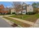 A suburban home with manicured lawn and landscaping on a tree-lined street at 7108 Kinley Commons Ln, Charlotte, NC 28278
