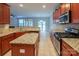 Bright kitchen with stainless steel appliances, granite counters, and tile flooring at 7108 Kinley Commons Ln, Charlotte, NC 28278