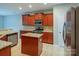 Open kitchen showcases stainless appliances, granite counters, tile flooring, and ample cabinet space at 7108 Kinley Commons Ln, Charlotte, NC 28278