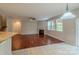 Spacious living room featuring hardwood floors, fireplace, large windows, and a ceiling fan at 7108 Kinley Commons Ln, Charlotte, NC 28278
