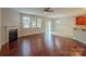Well-lit living room featuring hardwood floors, fireplace, and access to the outdoor area at 7108 Kinley Commons Ln, Charlotte, NC 28278