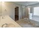Bright main bathroom showcasing dual sinks, vanity, a glass enclosed shower, and a tub at 7108 Kinley Commons Ln, Charlotte, NC 28278