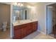Main bathroom showcasing a double vanity, a toilet, and a view of the shower at 7108 Kinley Commons Ln, Charlotte, NC 28278