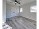 Spacious bedroom with wood-look floors, ceiling fan and double door closet at 8208 Doverdale Ln, Charlotte, NC 28217