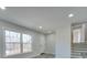 Bright entryway with two windows, white door, and hardwood floors at 8208 Doverdale Ln, Charlotte, NC 28217