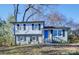 Newly renovated ranch home with a blue door and landscaped yard at 8208 Doverdale Ln, Charlotte, NC 28217