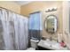 Bathroom includes updated fixtures and a decorative floral shower curtain at 8619 Delamere Ln, Charlotte, NC 28269