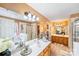 Bathroom featuring double sink vanity, a garden tub, and glass enclosed shower at 8619 Delamere Ln, Charlotte, NC 28269