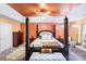 A sunlit bedroom showcases a four-poster bed, decorative lighting, and a large window at 8619 Delamere Ln, Charlotte, NC 28269