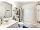 Clean bathroom with tub, toilet and shelving at 11001 Carmel Crossing Rd, Charlotte, NC 28226