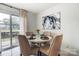 Charming dining area with a round table and four chairs, near sliding glass doors at 11001 Carmel Crossing Rd, Charlotte, NC 28226