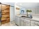 Modern kitchen with wood accent wall and stainless steel appliances at 11001 Carmel Crossing Rd, Charlotte, NC 28226