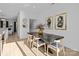 Sunlit dining room with modern table, chairs, artwork, and easy access to the kitchen at 13024 Moon Rd # 44, Charlotte, NC 28277