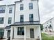 Charming two-story townhouse featuring a modern farmhouse design with white siding and black trim at 13024 Moon Rd # 44, Charlotte, NC 28277