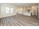 Open concept living room and kitchen with gray wood flooring, recessed lighting, and plenty of natural light at 1321 Morehead Dr, Salisbury, NC 28144