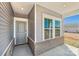 Welcoming front porch with stylish gray door, brick accents, and ample natural light at 1333 Morehead Dr, Salisbury, NC 28144