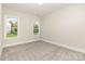 Neutral bedroom featuring carpet flooring, base trim, and two windows providing natural light at 267 Triple Ponds Ct # 11, Clover, SC 29710