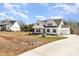Charming home showcasing a well-manicured lawn, long driveway and three-car garage at 267 Triple Ponds Ct # 11, Clover, SC 29710