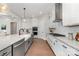 An open kitchen with an island and stainless steel appliances, featuring granite countertops and tile backsplash at 267 Triple Ponds Ct # 11, Clover, SC 29710