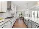 Contemporary kitchen with stainless steel appliances, white cabinets, gray island, and view into the dining area at 267 Triple Ponds Ct # 11, Clover, SC 29710
