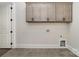 Laundry room has gray cabinets mounted along the wall with tile flooring at 267 Triple Ponds Ct # 11, Clover, SC 29710