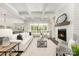 A spacious living room featuring a fireplace, plush seating, and a decorative ceiling with large windows and doors at 267 Triple Ponds Ct # 11, Clover, SC 29710